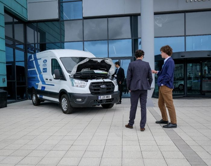 Two people looking at AVL Ford van