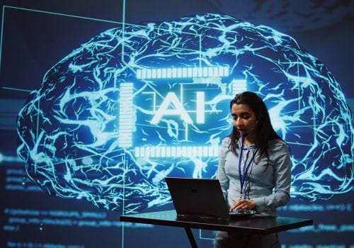 Technician in high tech workspace managing call center tasks, speaking into headset while doing monitoring with laptop. AI company employee talking with clients through headphones mic, camera B