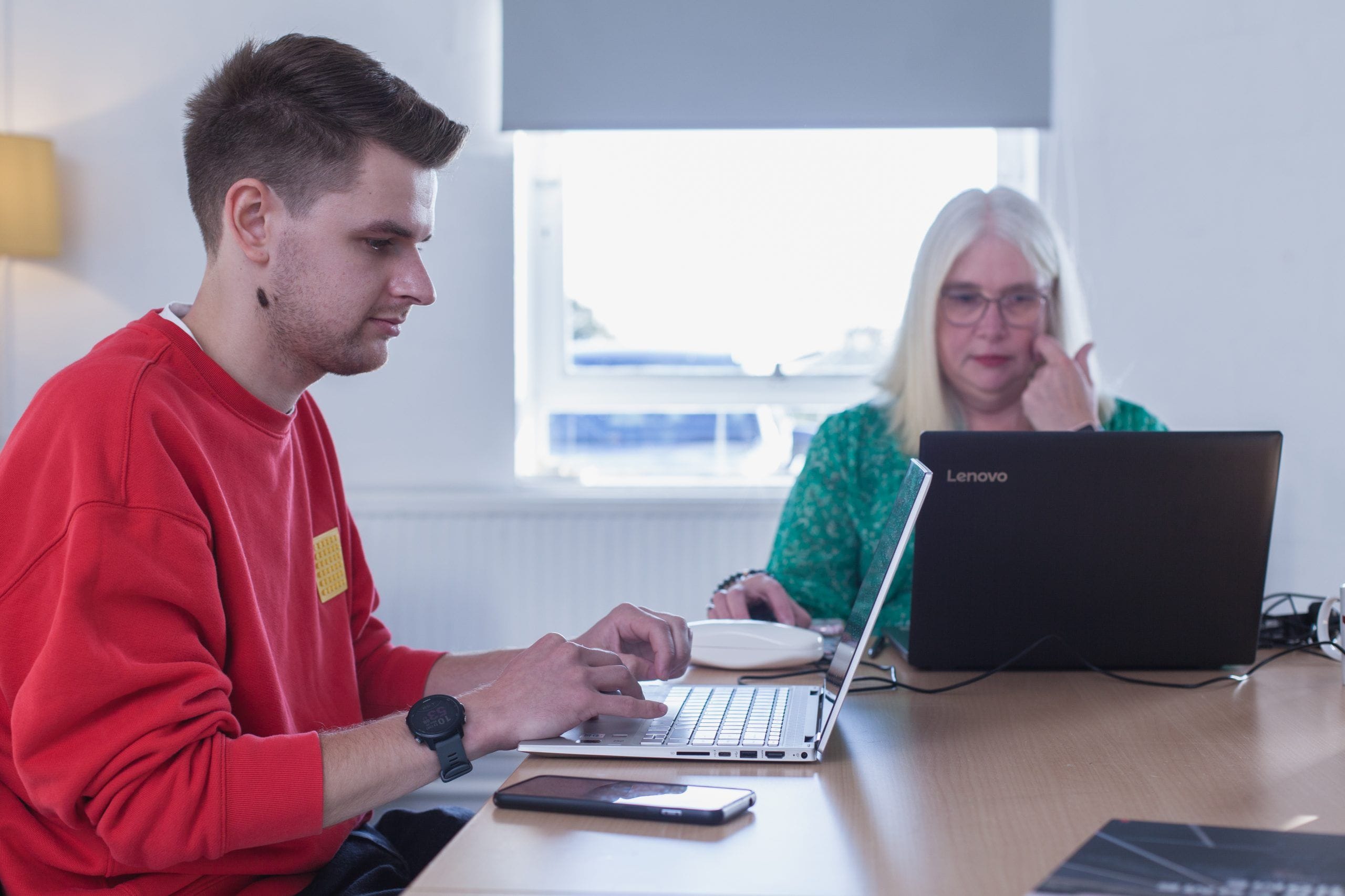 Man and woman working on laptops