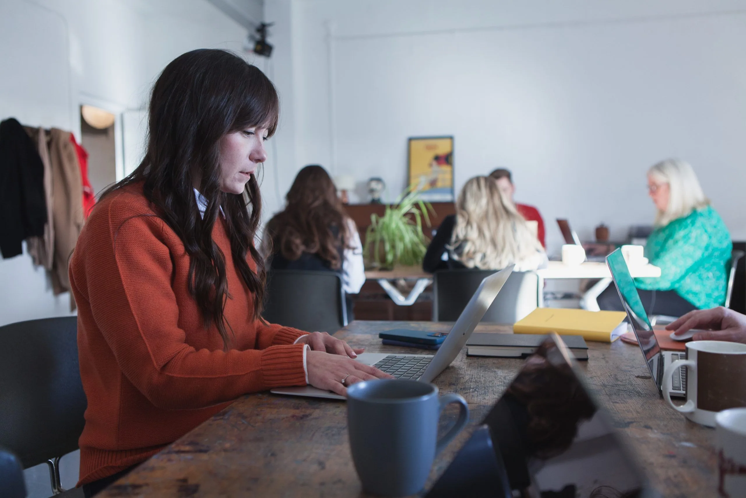 Woman in and office working on a laptop